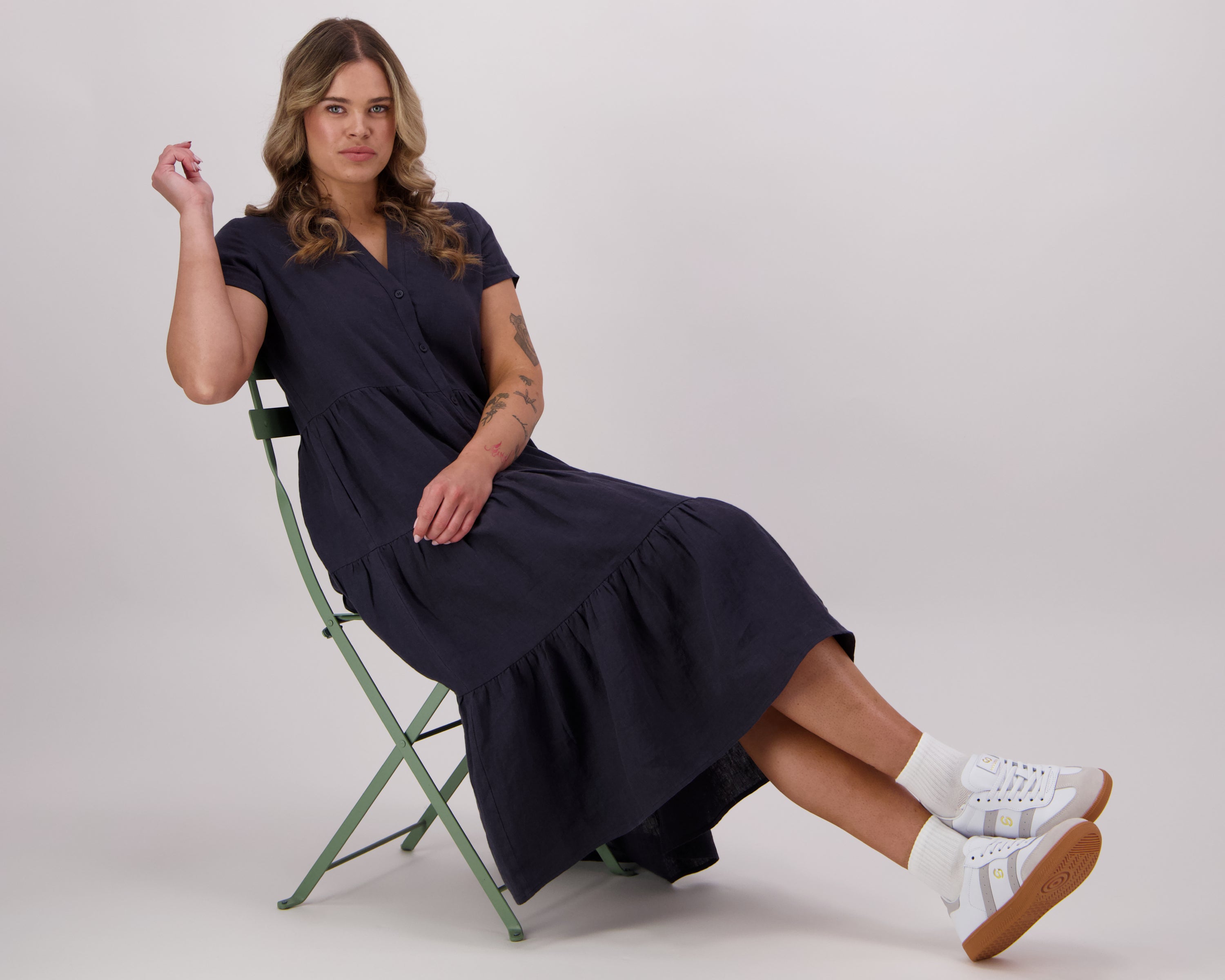 Woman wearing The Swan - a 100% natural linen dress in navy for Lennox St. the label.